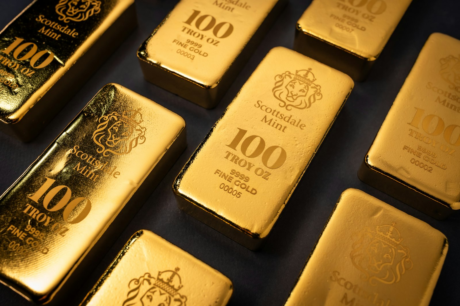 Gold bullion bars on a dark surface